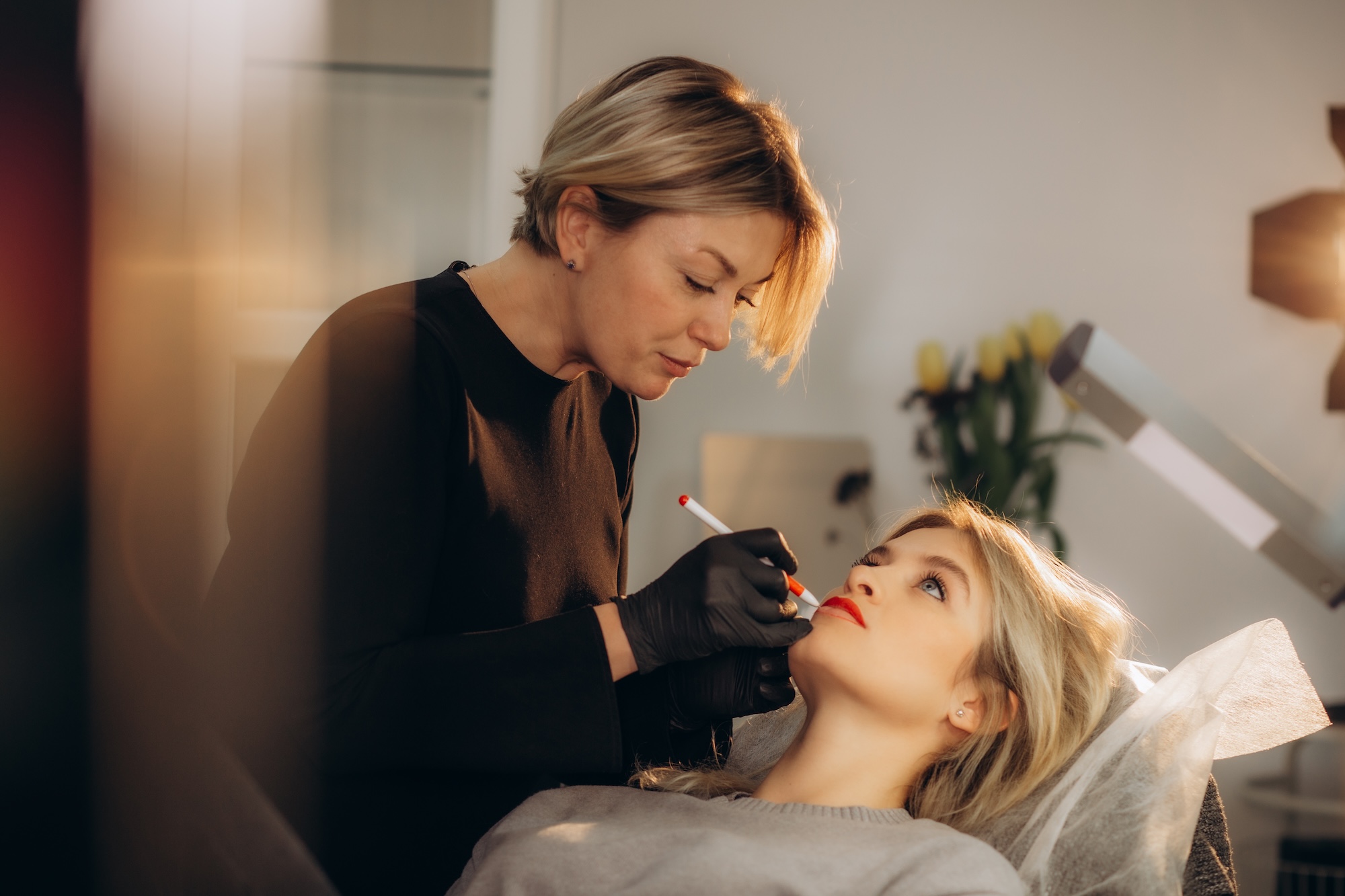 Woman laying down while professional adminsters massters Botox in Windermere, FL